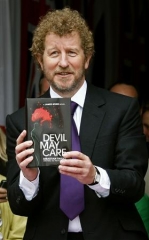 Sebastian Faulks holding Devil May Care